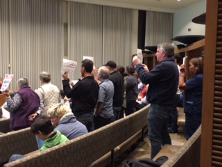 Community members, volunteers and Animal Shelter workers stand in solidarity at the October 17 city council meeting.